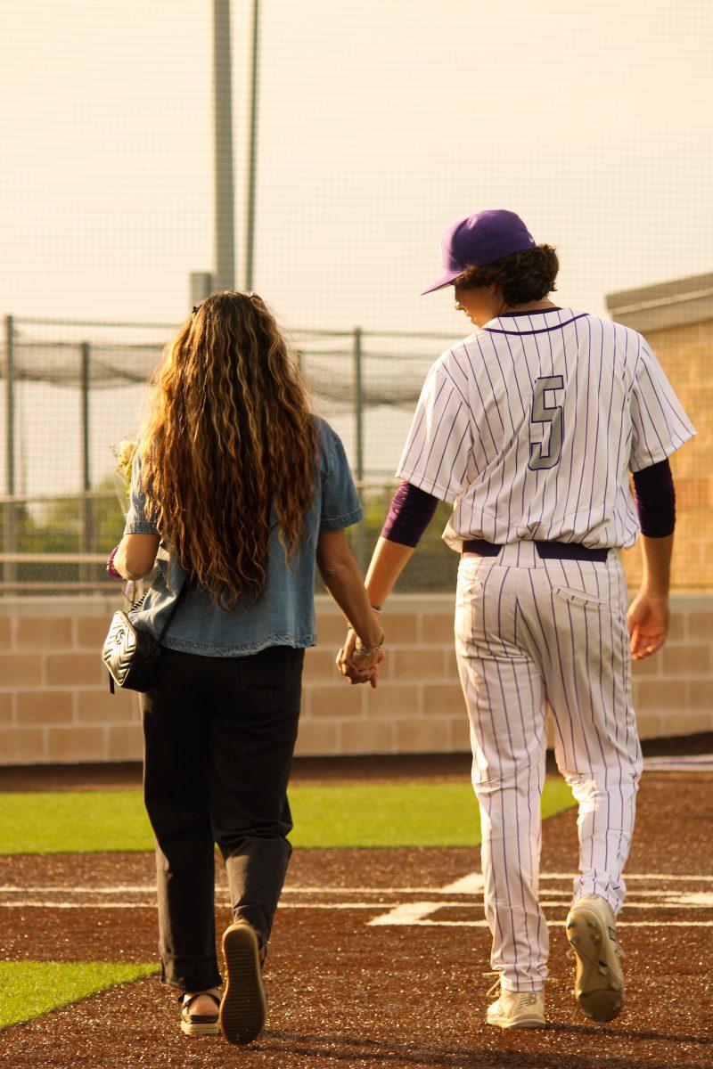 Senior Vlario Prado escorts his mother before his home game.