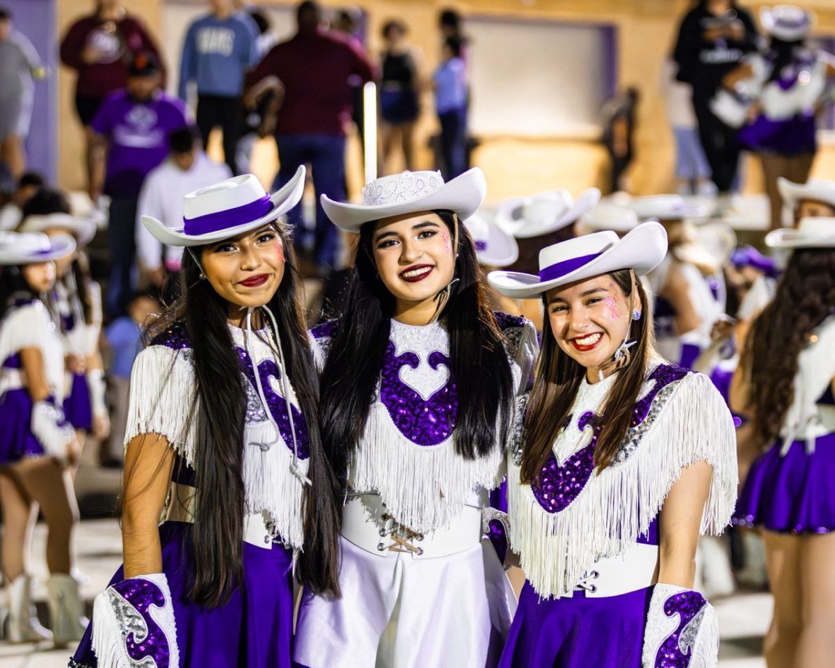 Miley Esquivel, Ava Maldonado, and Isabella Zertuche pose for a picture during the game.