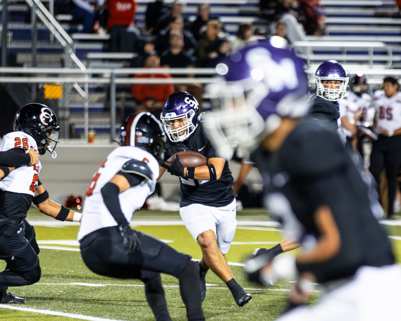 Senior, Ryan Leura, runs the ball up the field.