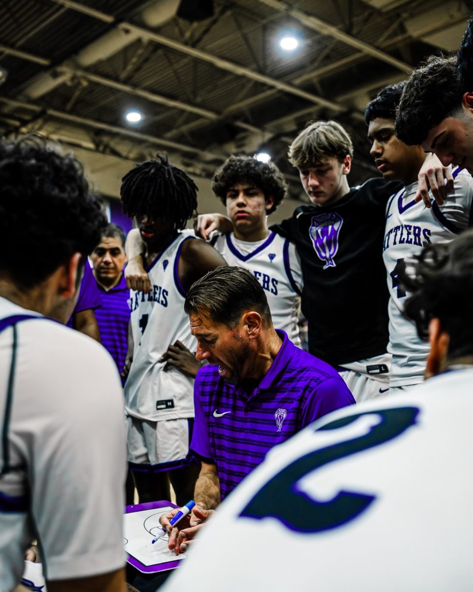 Coach, Dan Miller draws a play up to help his team.